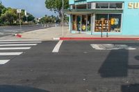 a car driving down the street with a sunbeam store in the background at an intersection