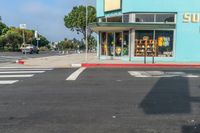 a car driving down the street with a sunbeam store in the background at an intersection