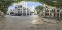 a street with a very wide angle lens with a large building in the distance as if to catch a traffic light,