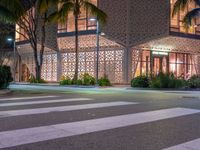 there is a crosswalk with white stripes on the road in front of a building