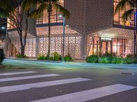 there is a crosswalk with white stripes on the road in front of a building