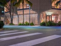 there is a crosswalk with white stripes on the road in front of a building