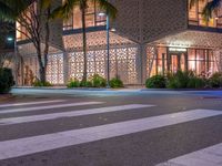 there is a crosswalk with white stripes on the road in front of a building