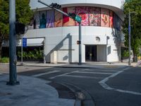 traffic lights, stoplights and a white building in the city of atlanta with street art on it