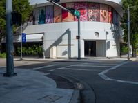 traffic lights, stoplights and a white building in the city of atlanta with street art on it