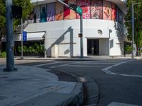 traffic lights, stoplights and a white building in the city of atlanta with street art on it