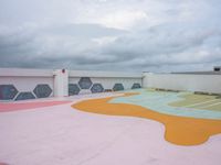 a colorful skate park area in the sky with clouds above it to provide an interesting environment