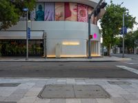 the sidewalk has lights on for people to walk through at night in the city area