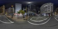 a 360 - view image of the street at night with buildings in the background from two perspective mirrors