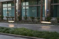 man on a sidewalk walking past building with palm trees in the background and light columns