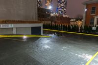 a parking space is surrounded by buildings and city lights at night in the rain of january