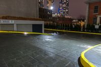 a parking space is surrounded by buildings and city lights at night in the rain of january