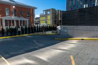 a yellow line marking down a parking lot near some buildings that are standing in the background