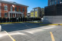 a yellow line marking down a parking lot near some buildings that are standing in the background