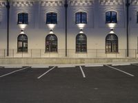 a very long building with a fire hydrant in front of it and some windows