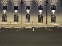 a very long building with a fire hydrant in front of it and some windows