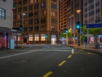 empty street at night in an urban area of the city with skyscrapers in the background