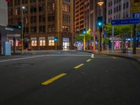 empty street at night in an urban area of the city with skyscrapers in the background