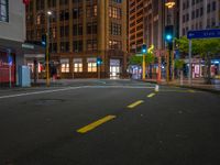 empty street at night in an urban area of the city with skyscrapers in the background