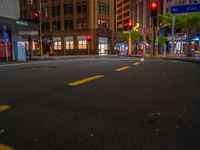 empty street at night in an urban area of the city with skyscrapers in the background