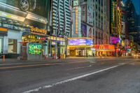 a busy intersection at night with traffic lights and building signs in the background with neon signs