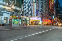 a busy intersection at night with traffic lights and building signs in the background with neon signs