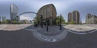 the reflection of some street lights on a city street is a fish eye view from an angle