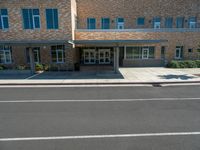 the city library building has white awnings on the front of it and is open to the street