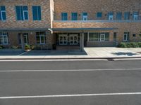 the city library building has white awnings on the front of it and is open to the street