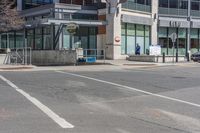 a car on the side of a street at an intersection with a bus stop sign