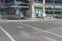 a car on the side of a street at an intersection with a bus stop sign