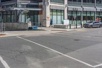 a car on the side of a street at an intersection with a bus stop sign