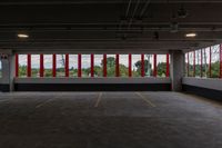 a large parking garage is shown with red and white stripes on the windows on the wall