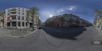 a fish eye view of two streets with cars driving on the road and buildings on the side