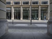 a clock is set at the corner of a building in this image, showing windows