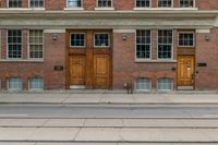 an old school building with wooden windows and a sign on the street that says parking