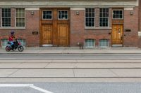 an old school building with wooden windows and a sign on the street that says parking