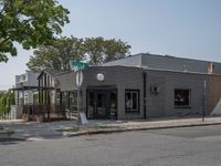 a store on the corner in a small town that has lots of gray brick walls