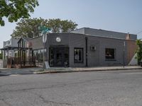 a store on the corner in a small town that has lots of gray brick walls