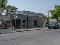 a store on the corner in a small town that has lots of gray brick walls