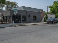 a store on the corner in a small town that has lots of gray brick walls