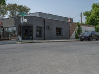 a store on the corner in a small town that has lots of gray brick walls