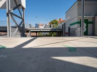 a big parking garage is empty on the street corner near the train station and some buildings