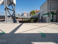 a big parking garage is empty on the street corner near the train station and some buildings