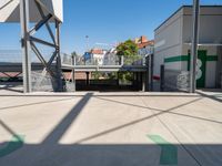 a big parking garage is empty on the street corner near the train station and some buildings