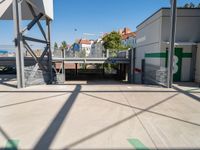 a big parking garage is empty on the street corner near the train station and some buildings