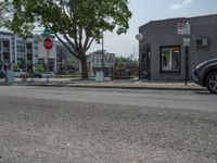 a store on the corner in a small town that has lots of gray brick walls