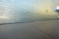 a skateboard is leaning against the side of a wall to move by the camera