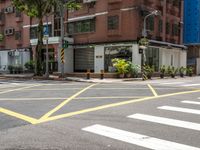 a crosswalk in a big city street that is not going much right into the city