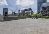 a park with some benches in the foreground and some buildings and buildings behind the area